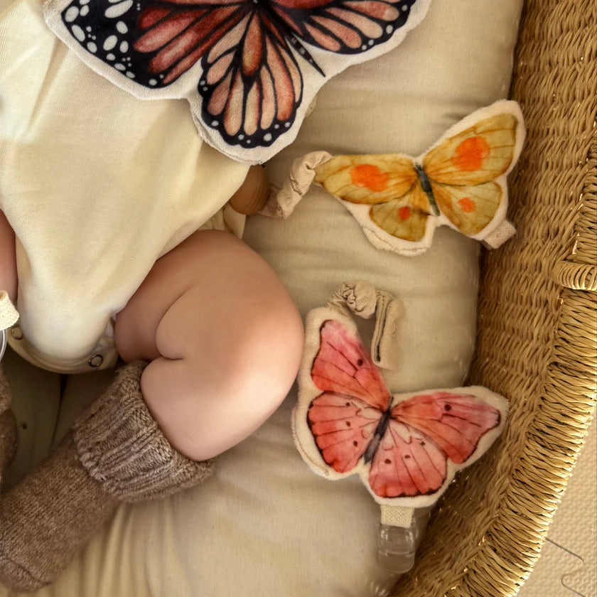 soft butterfly toy attached to dummy clip