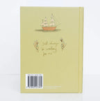 back blurb of Peter Pan limited collector’s edition hardcover by J.M. Barrie with green illustrated cover, gold foil title, cloth-bound finish and decorative sprayed edges, stacked on books.