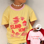 Child wearing Lokal Folk Traveller Tee reversible pink and yellow organic cotton t-shirt