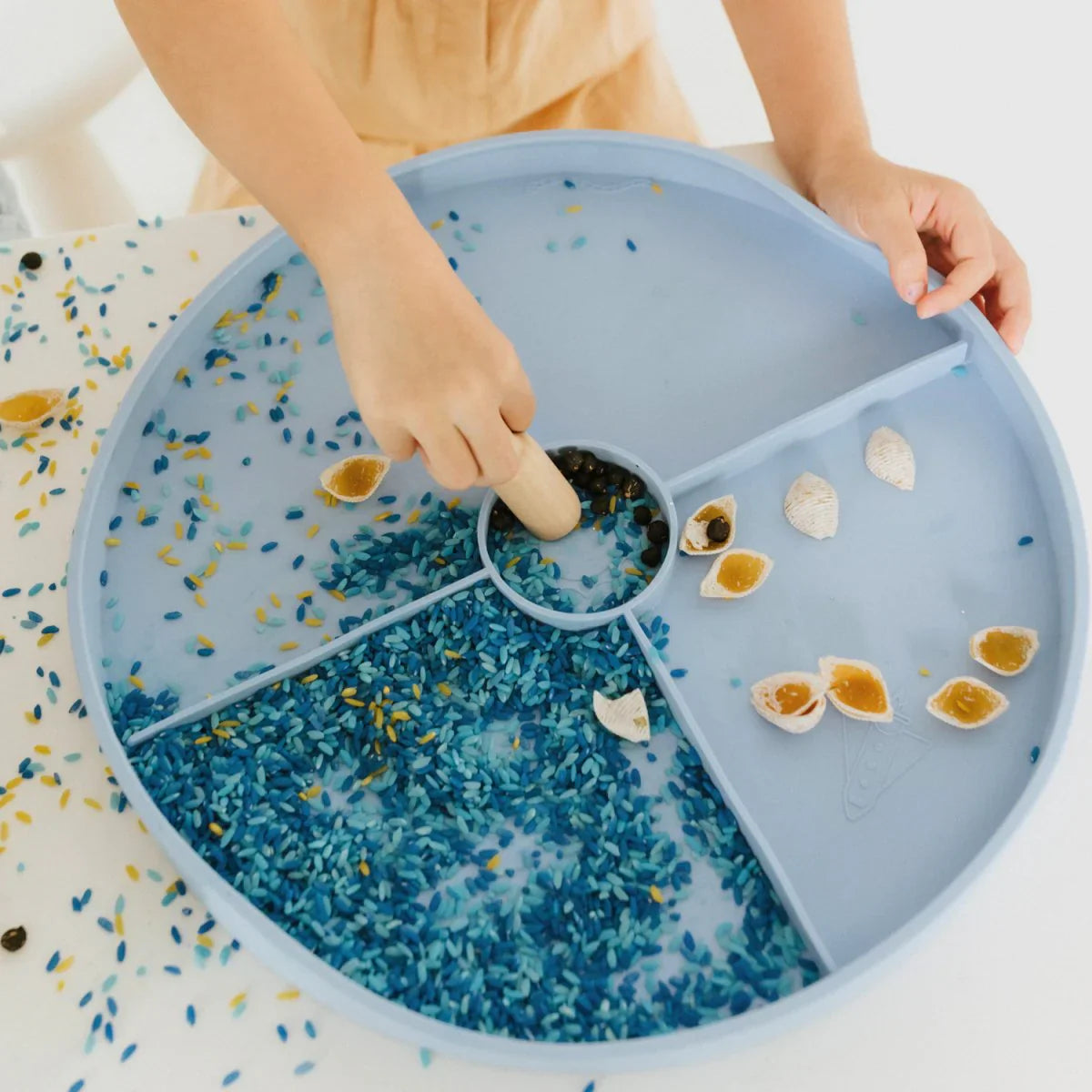 Toddler sensory tray in soft blue for open-ended play activities

