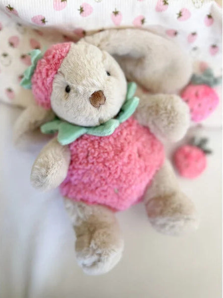 lifestyle image of bunny in a strawberry costume dress up like similar to jellycat. stock image - brand is Mon Ami. very cute plushy soft toy