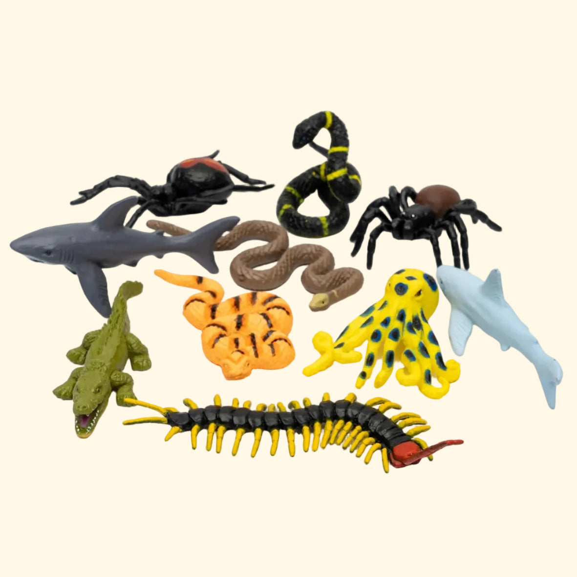 Assorted toy animals including a shark, crocodile, snake, and others on a white background
